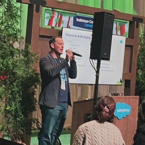 Jacob speaking on stage at a Salesforce event